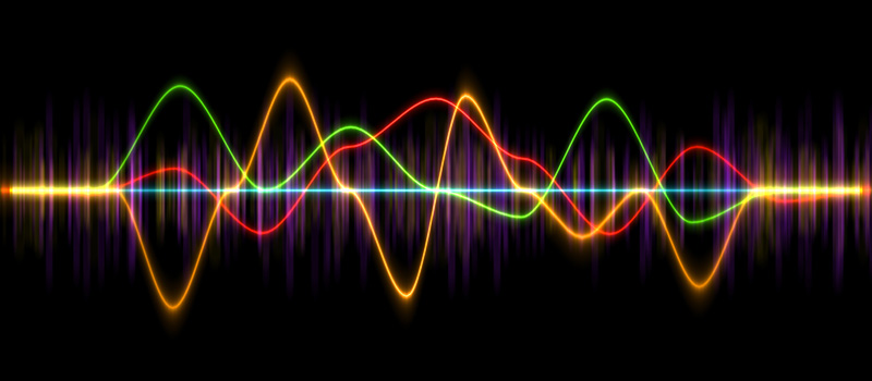 Frequency waveform in multiple colors on a black background
